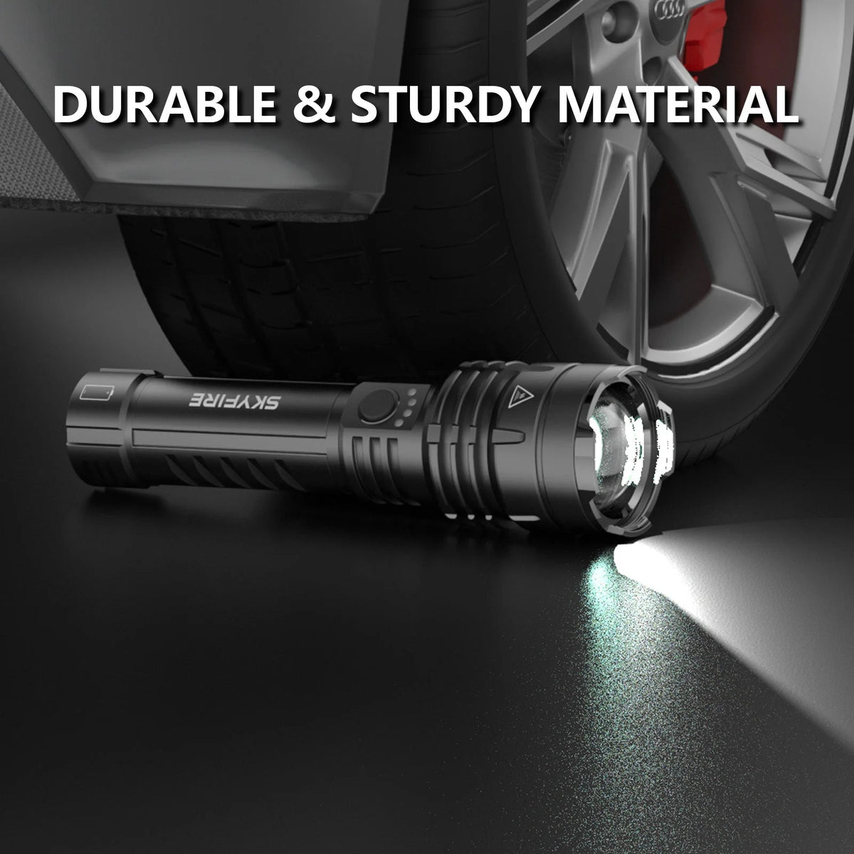 Black SkyFire 1376 flashlight positioned beside a vehicle tire with its beam switched on